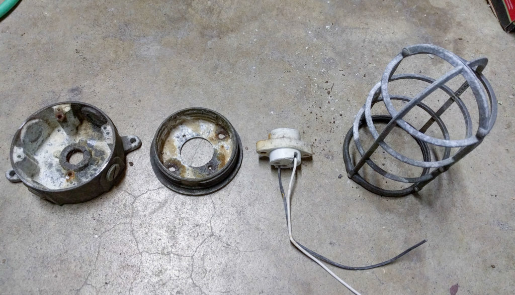 the major parts of an outdoor light, ready for cleaning