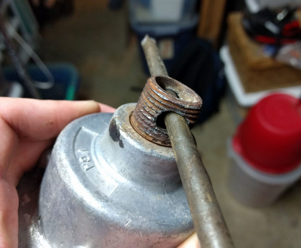 trying to unscrew a rusty metal pipe from a metal light fixture using a metal rod
