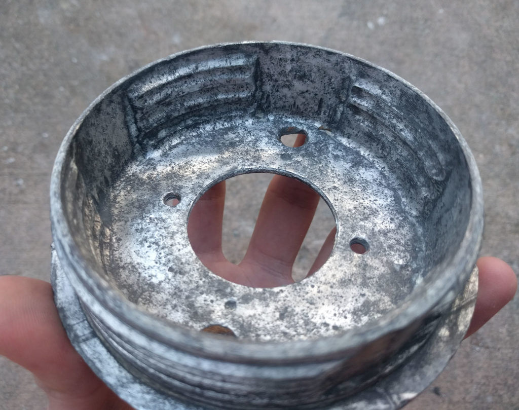 part of a metal light fixture after cleaning