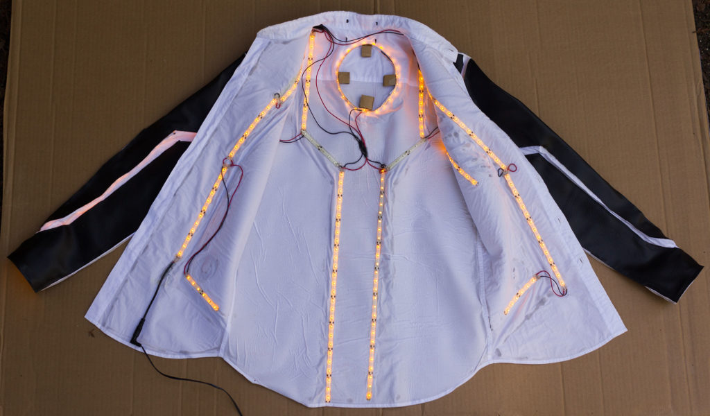 glowing amber LED strips laid out in a sci-fi pattern inside a white button-down shirt