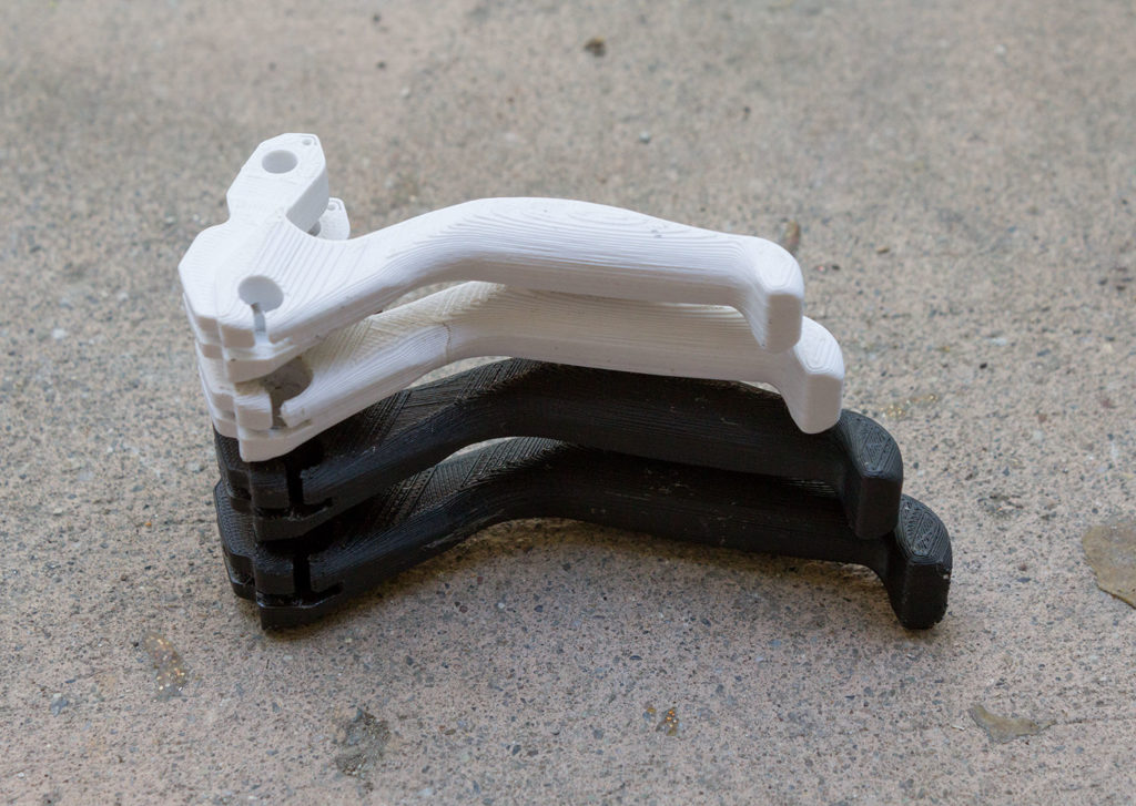 four 3D printed bicycle brake handles, printed in slightly different sizes