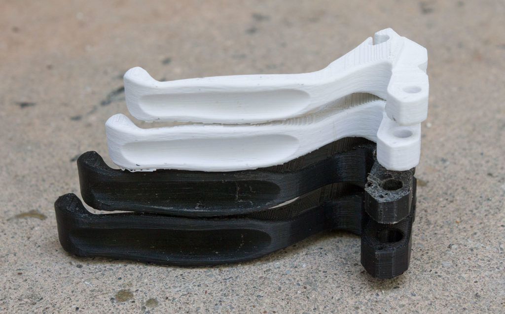 four 3D printed bicycle brake handles, printed in slightly different sizes